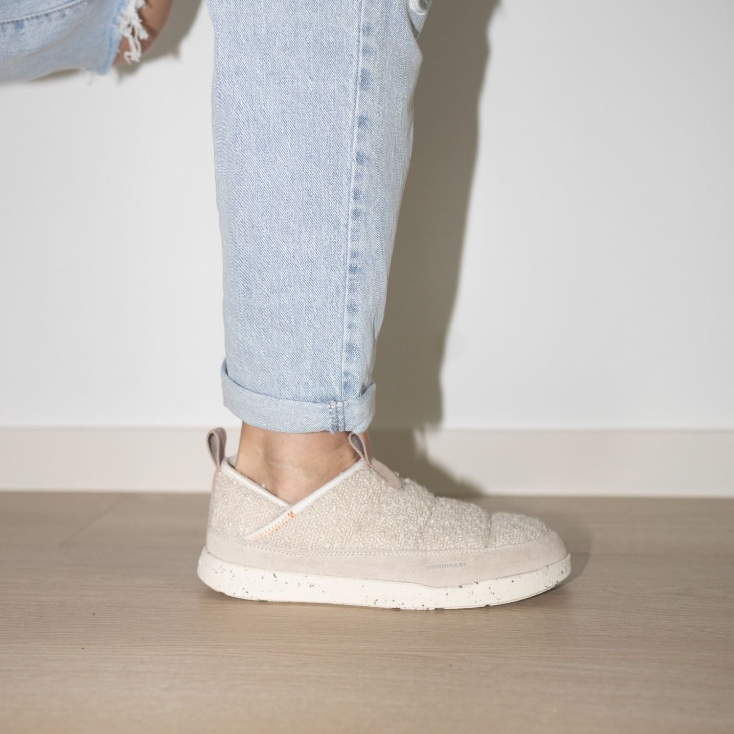 Beige slip-on shoes worn with light blue jeans 